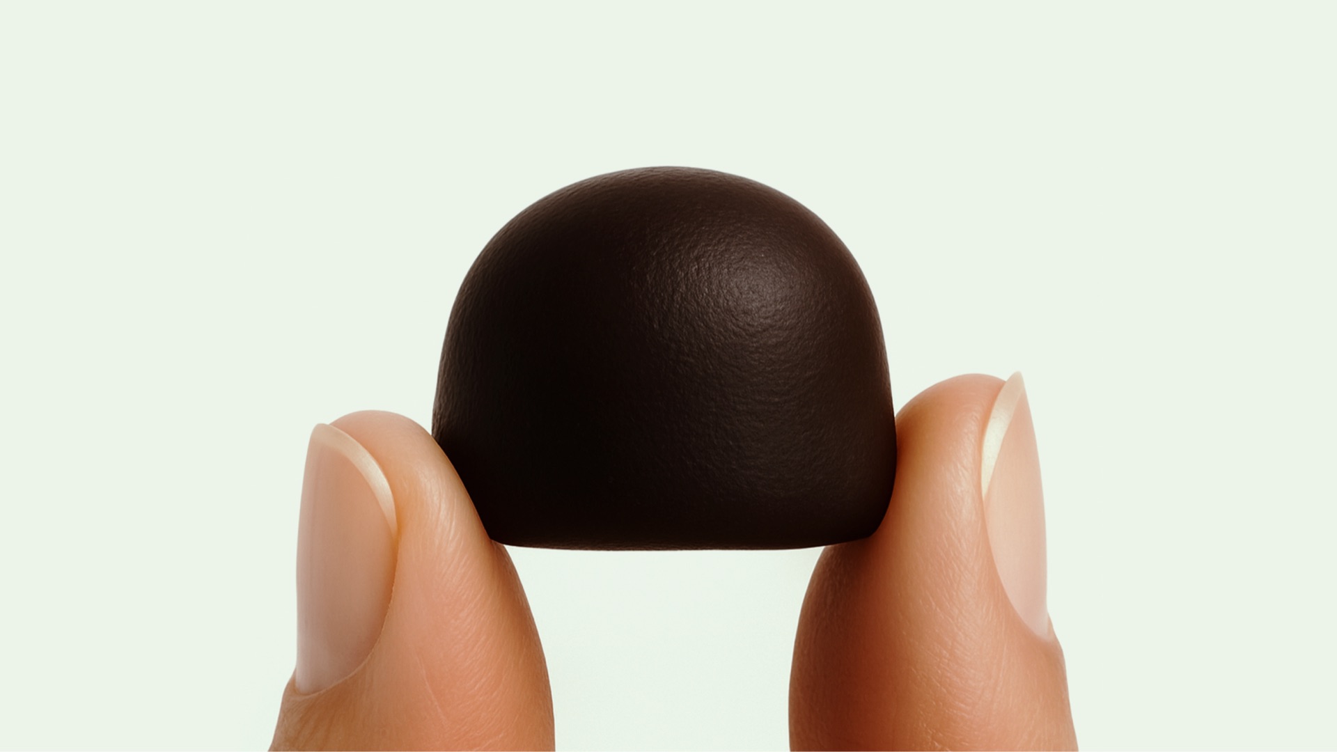 bodega gummy held between two fingers
